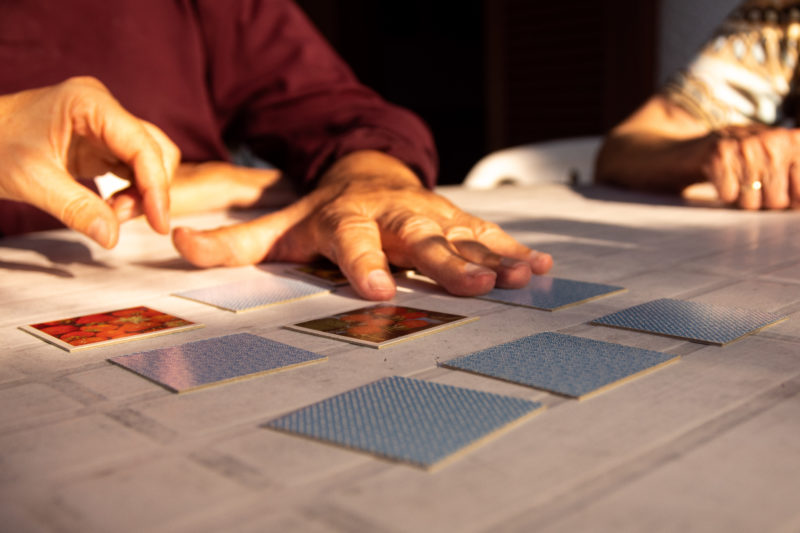 A stock photo for Demetia showing old hands doing a puzzle